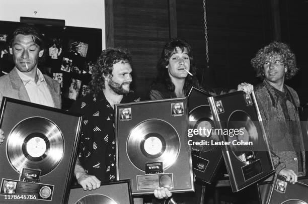 Alex Van, Michael Anthony, David Lee Roth and Sammy Hagar of Van Halen pose with platinum record sales plaques for the album '5150' circa 1986.