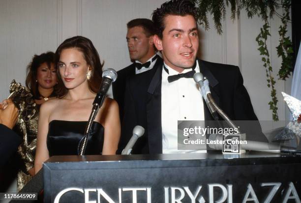 Marlee Matlin, and Charlie Sheen attend For Love Of Children AIDS Benefit Gala on July 8, 1988 at the Century Plaza Hotel in Century City, California.