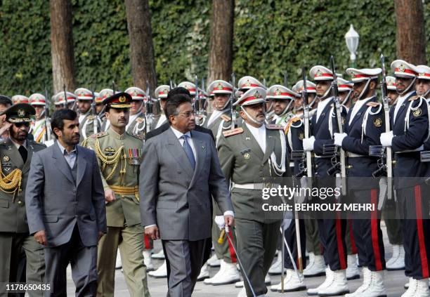 Iranian President Mahmoud Ahmadinejad reviews the honour guard with his Pakistani counterpart Pervez Musharraf during his welcoming ceremony in...