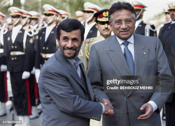 Iranian President Mahmoud Ahmadinejad shakes hands with his Pakistani counterpart Pervez Musharraf during his welcoming ceremony in Tehran 05...