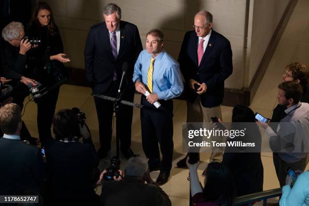 Reps. Jim Jordan, R-Ohio, center, Mark Meadows, R-N.C., left, and Mike Conaway, R-Texas, conduct a news conference in Capitol Visitor Center where...