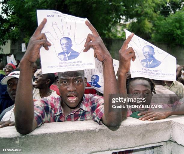 Supporters of Haitian president Jean Bertrand Aristide demonstrate 22 October in Port-au-Prince. The supporters protested the opposition's demand...