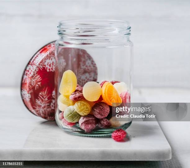 hard candy in a jar on white background - hard candy stock pictures, royalty-free photos & images