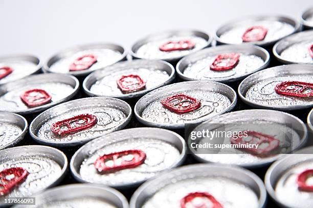 soda cans lined up with condensation on top - cola bottle stock pictures, royalty-free photos & images