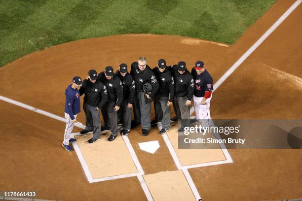 World Series: Aerial view of umpire posing with Houston Astros bench coach Joe Espada and Washington Nationals batting practice coach Ali Modami...
