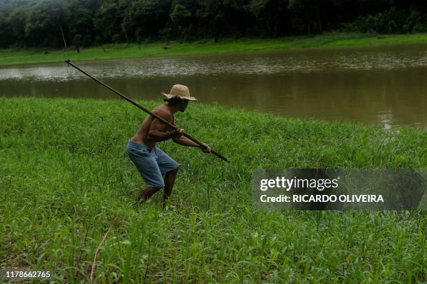 Fisherman approaches the bank of a river to catch Pirarucu at the Piagacu-Purus Sustainable Development Reserve in Amazonas state, Brazil, on October...