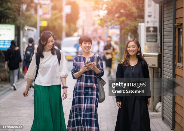 japanese women walking on shopping street - enoshima island stock pictures, royalty-free photos & images
