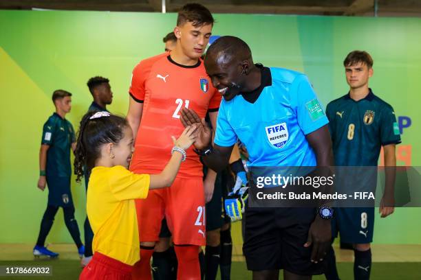 Assistant referee greets a child before the FIFA U-17 Men's World Cup Brazil 2019 group F match between Solomon Islands and Italy at Valmir Campelo...