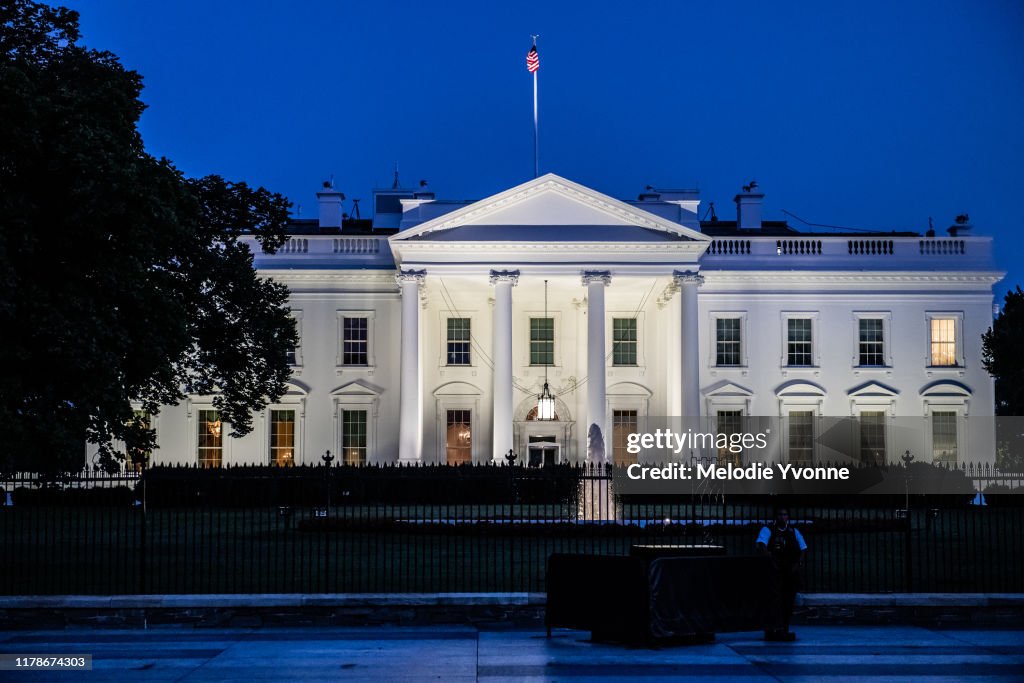 Horizontal color photo of White House in Washington DC on a clear summer evening