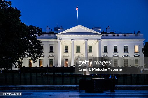 Horizontal color photo of White House in Washington DC on a clear summer evening