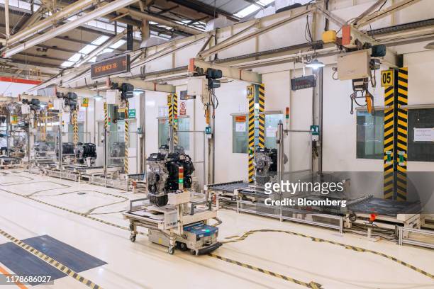 An automated guided vehicle , transports an engine to a test bench at the Sunter 1 Plant, an engine manufacturing facility operated by PT Toyota...