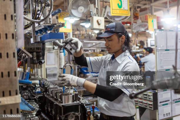 An employee works on an engine part at the Sunter 1 Plant, an engine manufacturing facility operated by PT Toyota Motor Manufacturing Indonesia , a...