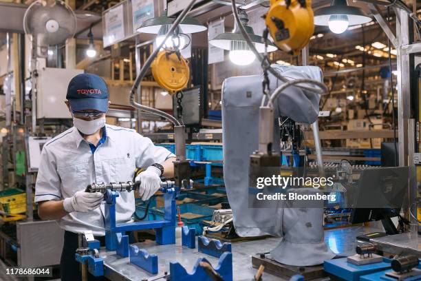An employee performs a quality check on engine parts at the Sunter 1 Plant, an engine manufacturing facility operated by PT Toyota Motor...
