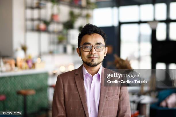 portrait of a young malay business man in a modern office - malay people stock pictures, royalty-free photos & images