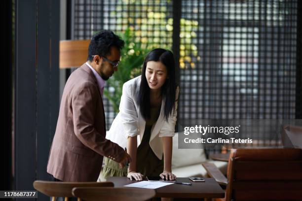 colleauges working together in an office - chinese indonesians stock pictures, royalty-free photos & images