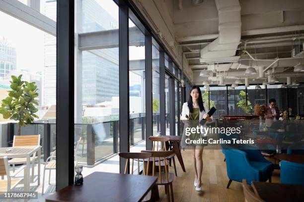 business woman walking into work with computer and water bottle - reusable water bottle office stock pictures, royalty-free photos & images