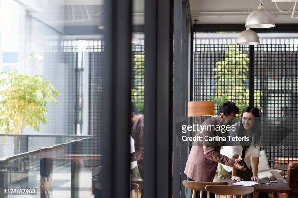 colleauges working together in an office - asia business stock pictures, royalty-free photos & images