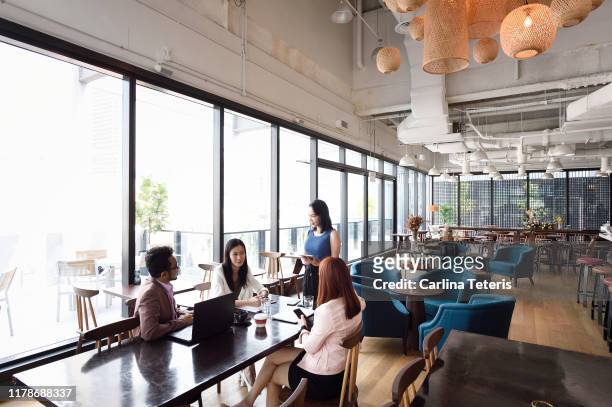 Woman leading a business meeting in an open office