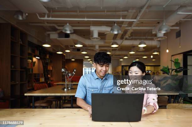 chinese woman and teenager using a computer together - trainee program stock pictures, royalty-free photos & images