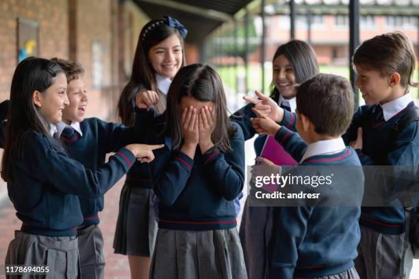 kids bullying a girl at the school - bullying stock pictures, royalty-free photos & images