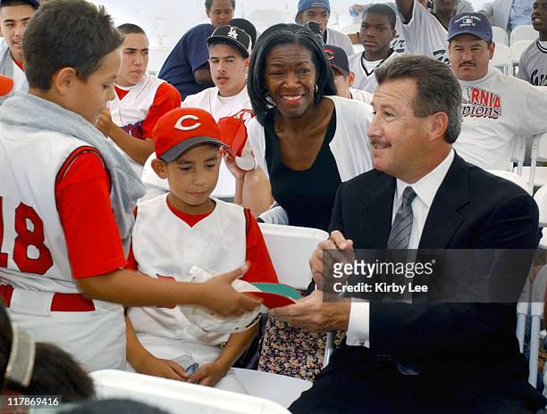 Anaheim Angels owner Arturo Moreno signs autographs for members of the Compton CBATS age 10 and under youth baseball team at ground breaking for...