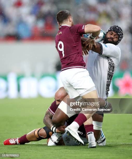 Peceli Yato of Fiji is tackled by Vasil Lobzhanidze and Mikheil Nariashvili of Georgia during the Rugby World Cup 2019 Group D game between Georgia...