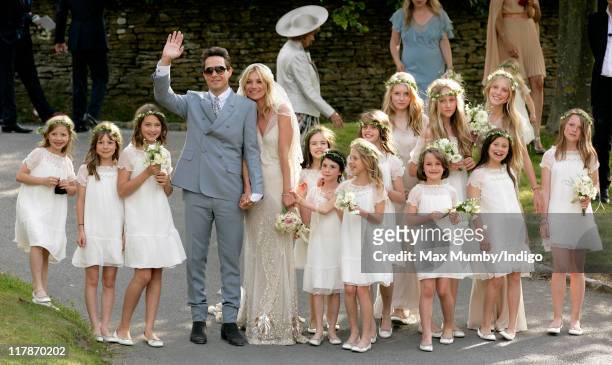 Jamie Hince and Kate Moss pose for photographs as they leave St. Peter's Church after their wedding on July 1, 2011 in Abingdon, England.