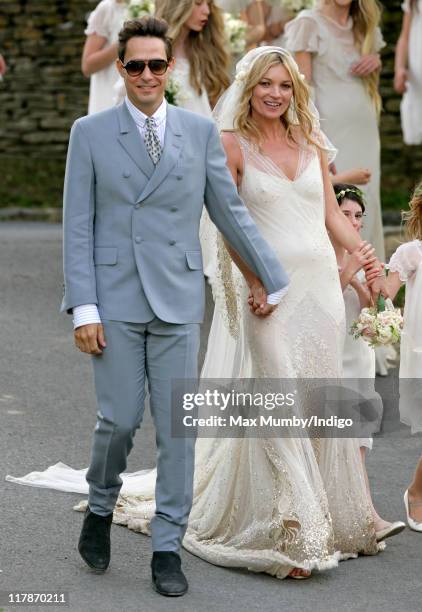 Jamie Hince and Kate Moss pose for photographs as they leave St. Peter's Church after their wedding on July 1, 2011 in Abingdon, England.