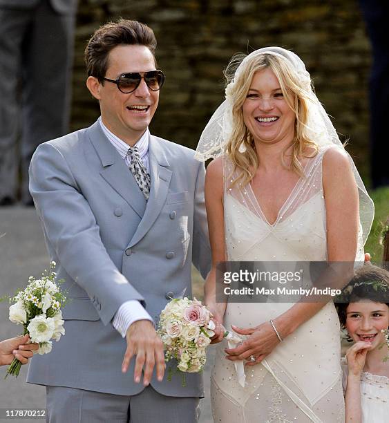 Jamie Hince and Kate Moss pose for photographs as they leave St. Peter's Church after their wedding on July 1, 2011 in Abingdon, England.