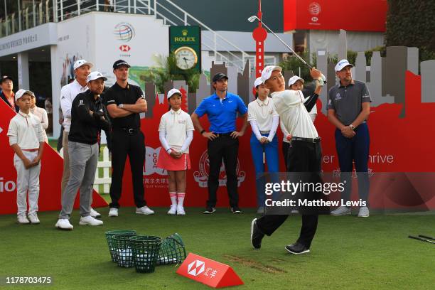 Ian Poulter of England, Xander Schauffele of the United States, Haotong Li of China, Rory McIlroy of Northern Ireland and Justin Rose of England hold...