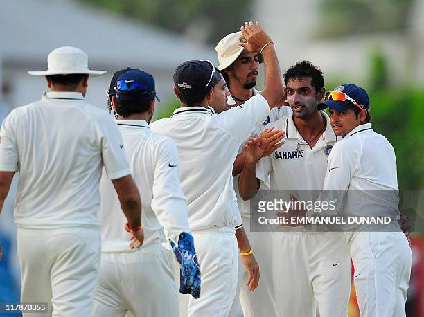 Indian bowler Abhimanyu Mithun celebrates after taking the wicket of West Indies batsman Darren Bravo during the first day of the second test match...