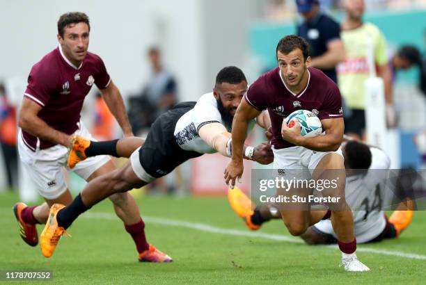 Soso Matiashvili of Georgia escapes the tackle of Waisea Nayacalevu of Fiji during the Rugby World Cup 2019 Group D game between Georgia and Fiji at...