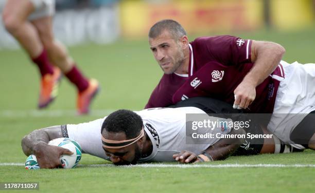 Apisalome Ratuniyarawa of Fiji scores his team's sixth try as he is tackled by Lasha Khmaladze of Georgia during the Rugby World Cup 2019 Group D...