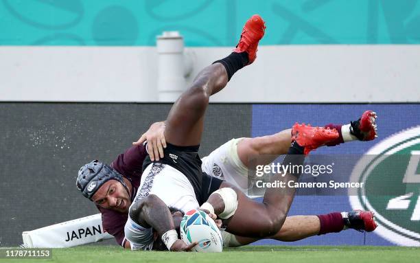 Semi Radradra of Fiji scores his team's seventh try past Beka Gorgadze of Georgia during the Rugby World Cup 2019 Group D game between Georgia and...
