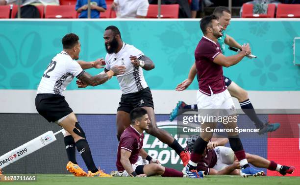 Semi Radradra of Fiji celebrates scoring his team's seventh try with Jale Vatubua of Fiji during the Rugby World Cup 2019 Group D game between...