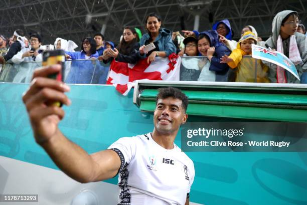 Ben Volavola of Fiji takes a selfie with fans following victory in the Rugby World Cup 2019 Group D game between Georgia and Fiji at Hanazono Rugby...
