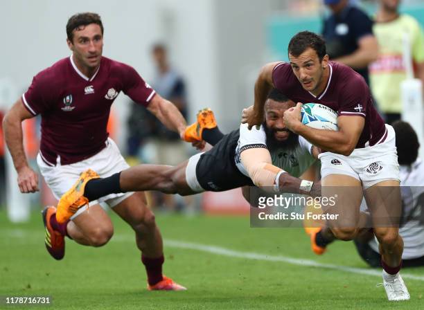 Georgia fullback Soso Matiashvili escapes the diving tackle of Waisea Nayacalevu during the Rugby World Cup 2019 Group D game between Georgia and...