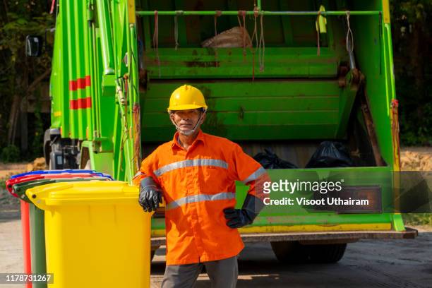 municipal worker recycling garbage collector truck loading waste and trash bin - dustman stock pictures, royalty-free photos & images