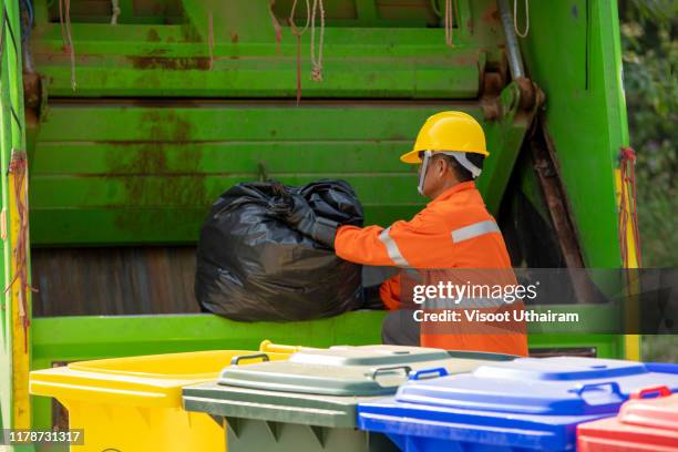 municipal worker recycling garbage collector truck loading waste and trash bin - dustman stock pictures, royalty-free photos & images