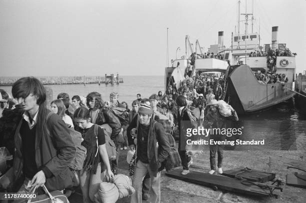 Festival goers and music fans walk off the Lymington to Yarmouth ferry at Yarmouth harbour on the Isle of Wight to attend the Isle of Wight Festival...