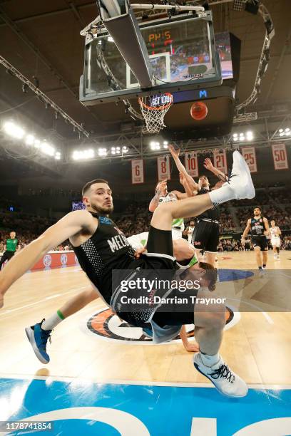 Chris Goulding of United fouls Ben Madgen of the Phoenix as he drives to the basket during the round one NBL match between Melbourne United and the...