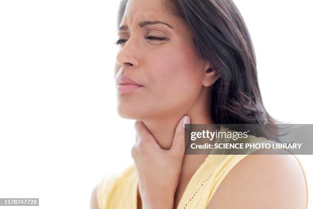 woman touching her throat in pain - throat stock pictures, royalty-free photos & images