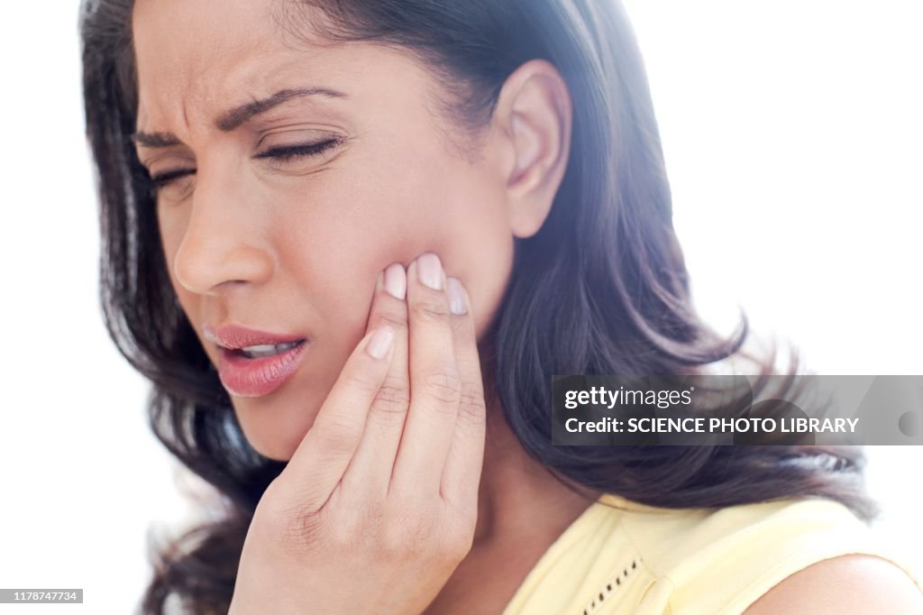 Woman touching her cheek in pain