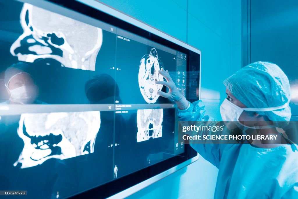 Surgeon looking at MRI scans
