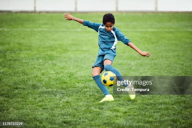 young teenager executes a perfect soccer volley. - shooting football stock pictures, royalty-free photos & images