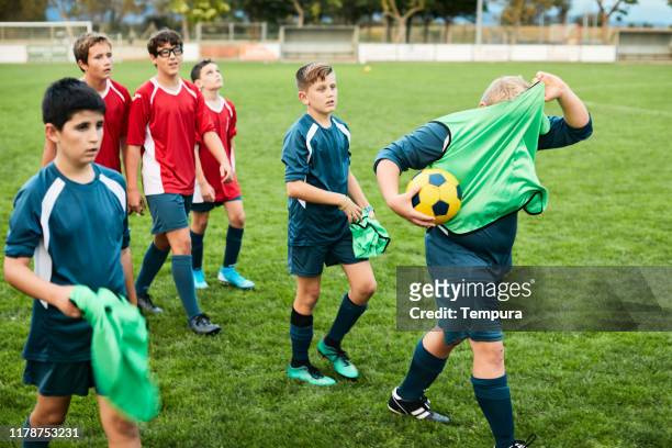 teenage soccer players leave the field after a training session. - soccer team stock pictures, royalty-free photos & images
