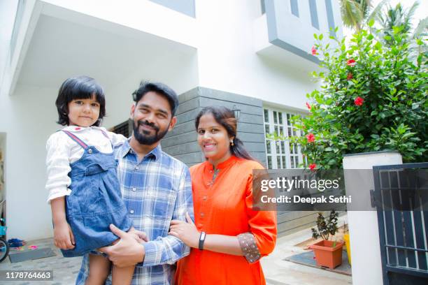 portrait of family standing outside home stock photo - south india stock pictures, royalty-free photos & images