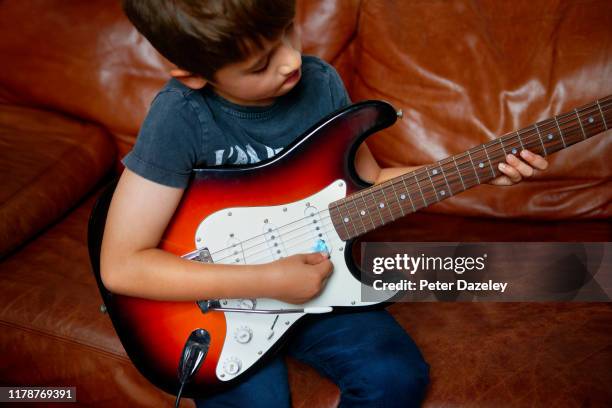 child prodigy playing electric guitar - child prodigy stock-fotos und bilder