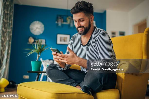 man using phone - at home stock pictures, royalty-free photos & images