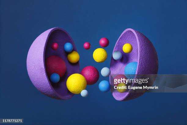 Abstract multi-colored objects levitation in mid air on blue background